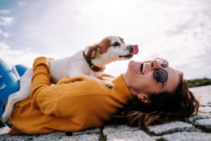 woman-laughing-while-her-pet-is-licking-her-face