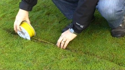 Man installing an in-ground invisible fence wire